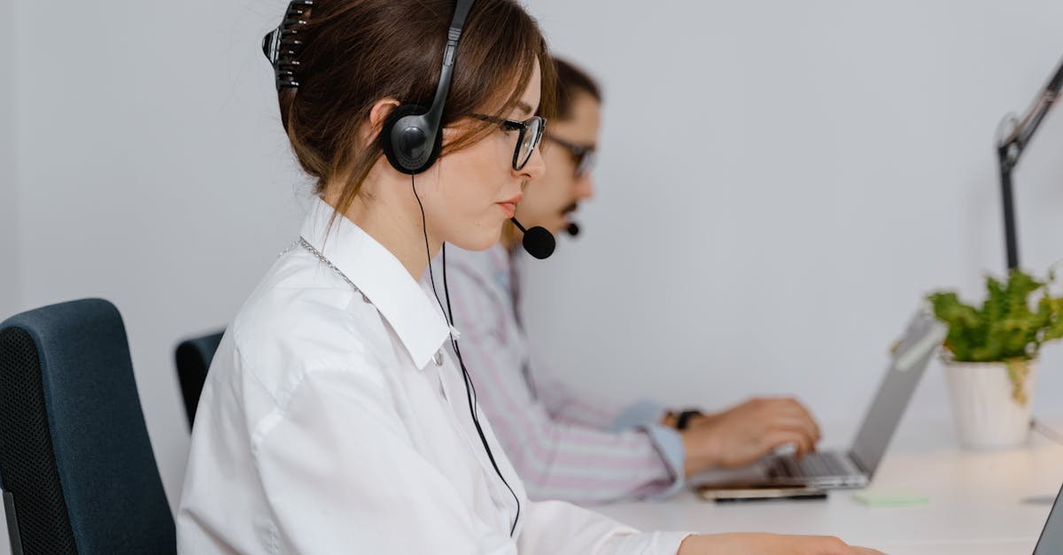Customer service agents working at call center with headsets, focused on providing support.